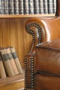 Old leather chair and wooden bookcase Royalty Free Stock Photo