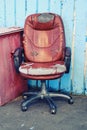 Old leather computer chair thrown into the street, bankrupt concept and business problems Royalty Free Stock Photo