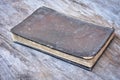 Old leather cover book on wood background.