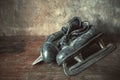 Old leather figure skates in black on a retro background Royalty Free Stock Photo