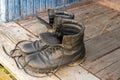 Old leather Hiking boots on the porch of a village house. Summer is a time of travel. Close up Royalty Free Stock Photo