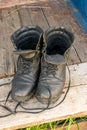 Old leather Hiking boots on the porch of a village house. Summer is a time of travel. Close up Royalty Free Stock Photo