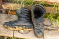 Old leather Hiking boots on the porch of a village house. Summer is a time of travel. Close up Royalty Free Stock Photo