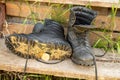 Old leather Hiking boots on the porch of a village house. Summer is a time of travel. Close up Royalty Free Stock Photo