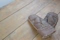 Old leather mittens and scarf on wood table Royalty Free Stock Photo