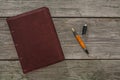 Old leather notebook and fountain pen on old wooden boards Royalty Free Stock Photo