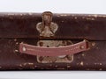 old leather suitcase shabby tattered with metal locks on a white background