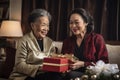 old lesbian middle aged couple giving gifts and presents to each other, female gay lgbt homosexual asian marriage or girlfriends Royalty Free Stock Photo