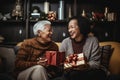 old lesbian middle aged couple giving gifts and presents to each other, female gay lgbt homosexual asian marriage or girlfriends Royalty Free Stock Photo