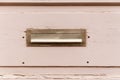 Old letterbox or mailbox in the wooden gate door traditional way of delivering letters or mail to the house address close up Royalty Free Stock Photo