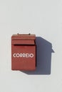 Old letterbox at a white painted wall with painted Correio - engl: postl Royalty Free Stock Photo
