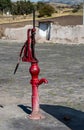 Red old lever pump to lift the water from the well