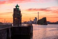 Old lghthouse overlooking a river port at sunset Royalty Free Stock Photo