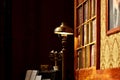 Old library with retro lamp, piano, music sheets, candlestick, books, theatre decoration on stage Royalty Free Stock Photo