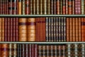 Old library of vintage hard cover books on shelves Royalty Free Stock Photo