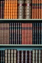 Old library of vintage hard cover books on shelves vertical Royalty Free Stock Photo