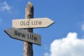 Old life and new life - wooden signpost with two arrows Royalty Free Stock Photo