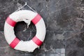 old lifebuoy with rope on the wall Royalty Free Stock Photo