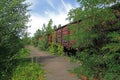 Abandoned rusty wagons on railway tracks on the empty platform Royalty Free Stock Photo