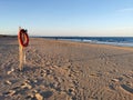 The old lifeline against the sea hangs on the beach with copy space Royalty Free Stock Photo