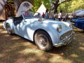 Old light blue sport 1950s Triumph TR3 A sport roadster in a park. Autoclasica 2022 classic car show