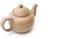 Old light brown clay teapot with cracks and scratches on white background Royalty Free Stock Photo