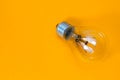 Old light bulb on yellow background close-up Royalty Free Stock Photo