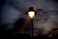 An old light glowing in a beach