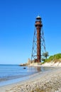 Old lighthouse on the beach near the sea. Royalty Free Stock Photo