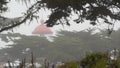 Old lighthouse fresnel lens glowing, foggy rainy weather. Illuminated beacon USA Royalty Free Stock Photo