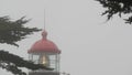 Old lighthouse fresnel lens glowing, foggy rainy weather. Illuminated beacon USA Royalty Free Stock Photo