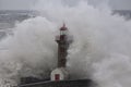 Old lighthouse in the middle of stormy waves Royalty Free Stock Photo