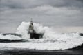 Old lighthouse in the sea in stormy day Royalty Free Stock Photo