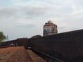 An old lighthouse standing inside fort on the seashore in goa. Name of place is aguada fort. Royalty Free Stock Photo