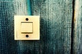 Old Lighting Switch on the wood wall. Close up hand turning on or off on grey light switch with wooden background. Copy space Royalty Free Stock Photo