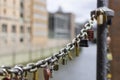 On an old link chain of the Speicherstadt in Hamburg hang many colorful so-called love locks in different shapes. The Royalty Free Stock Photo