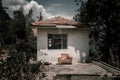 Old little abandoned house. Beautiful trees. Clouds in the blue sky. Royalty Free Stock Photo