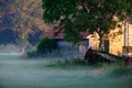 Old little barn in misty countryside