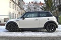 Old classic small supermini subcompact car white Mini Cooper parked in snow Royalty Free Stock Photo