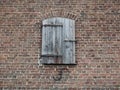 An old little wooden door in the middle of a brick wall. Royalty Free Stock Photo