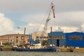 Old loading ship with jib crane near the Klaipeda. Royalty Free Stock Photo