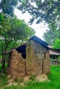Old local traditional house, made of soil. Concept of poverty, primitive homes, poor simple settlements in villages. Royalty Free Stock Photo