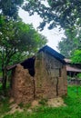 Old local traditional house, made of soil. Concept of poverty, primitive homes, poor simple settlements in villages. Royalty Free Stock Photo