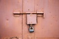 Old lock of the metal door. Rusty old metal texture with remnants of the paint. Royalty Free Stock Photo