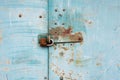 Old lock of the metal door. Rusty old metal texture with remnants of the paint. Royalty Free Stock Photo