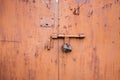 Old lock of the metal door. Rusty old metal texture with remnants of the paint. Royalty Free Stock Photo