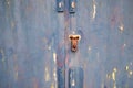 Old lock of the metal door. Rusty old metal texture with remnants of the paint. Royalty Free Stock Photo