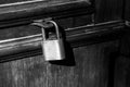 Old lock on a wooden door with rusty closed padlock, Vintage Black and white photo Royalty Free Stock Photo