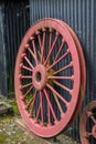 Old locomotive red wheel, leaning against a shed. Selective view. Royalty Free Stock Photo