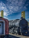 Old locomotive and train car parked on tracks in front of the tower bridge